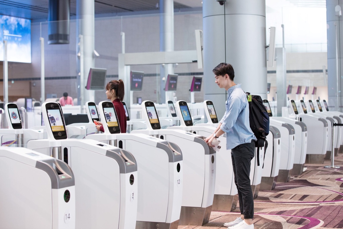 Travellers at automated passport gates in an airport